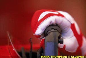 Michael Schumacher's gloved hand on a molded Ferrari steering wheel