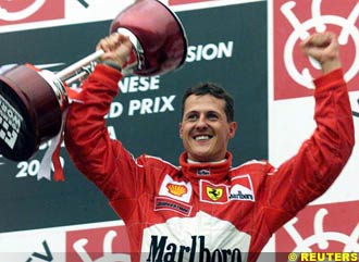 Michael Schumacher raising the winner's trophy at the Japanese Grand Prix 2000