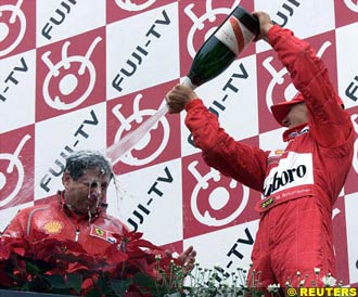Schumacher sprays Todt with Champagne