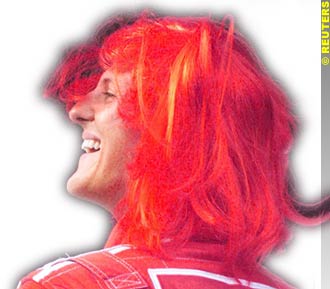 Michael Schumacher celebrates his win with a red wig