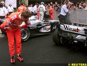 Schumacher inspects the McLaren after the Brazilian GP