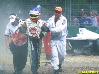 Villeneuve helped away from his car after the crash