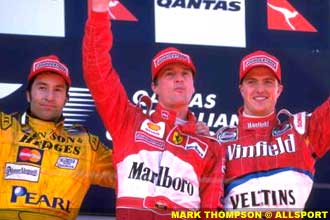 Ferrari's Eddie Irvine celebrates victory with 2nd placed Heinz-Harald Frentzen and 3rd placed Ralf Schumacher in the Formula One Australian Grand Prix, 1999