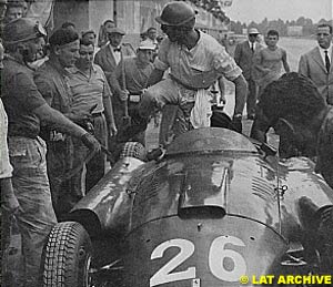 Collins gets out of his car to give it to Fangio, at the 1956 Italian GP