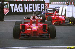 Michael Schumacher wins the 1997 Japanese GP with Irvine's help