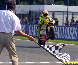 Valentino Rossi takes the chequered flag at Brno