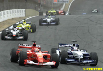 Montoya comes up to pass Schumacher