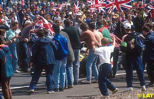 Williams driver Nigel Mansell is surrounded by fans after his 1992 win at Silverstone