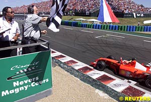 Michael Schumacher taking the checkered flag