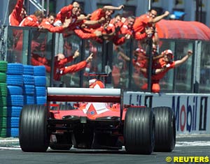 The Ferrari team celebrating Michael Schumacher's 50th GP win