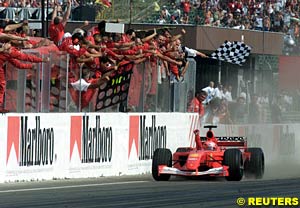 Michael Schumacher takes the flag as winner of the 2001 Hungarian Grand Prix  