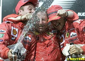 Rubens Barrichello, Jean Todt and Michael Schumacher, celebrating on the podium  