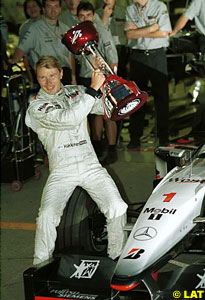Mika Hakkinen with his 1999 Drivers' WC trophy