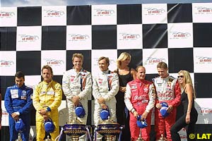 Stefan Johansson and Patrick Lemarie stand on top of the podium
