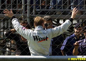 Mika Hakkinen waves to the crowd after retiring from the race