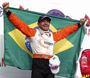 Winner Roberto Moreno holds the Brazilian flag on the Vancouver podium