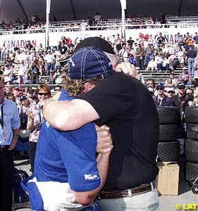 An emotional Alex Tagliani is consoled by Ric Moore after receiving the Greg Moore Pole Award