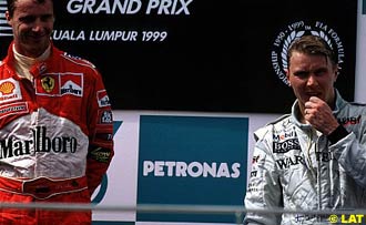 Eddie Irvine and Mika Hakkinen on the podium, Malaysian Grand Prix, Sepang, 1999