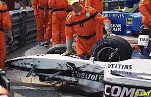Marshalls gather the remains of Ralf Schumacher's stricken Williams after he crashed out of the 2000 Monaco GP