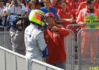 Michael Schumacher, Ferrari, congratulates brother Ralf Schumacher, Williams