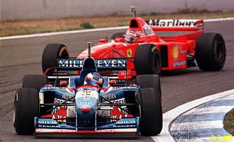 Jean Alesi, Benetton B197-Renault, leading Michael Schumacher, Ferrari F310B, 1997 Spanish Grand Prix.