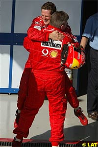 Michael Schumacher celebrates his victory with Ross Brawn