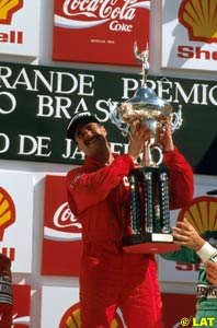 Nigel Mansell lifting the winner's trophy
