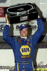 Michael Waltrip holds the winner's trophy at Daytona again, this time in happier circumstances