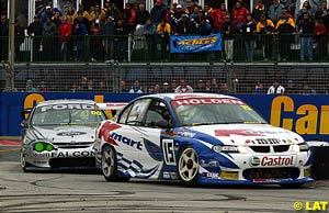 Todd Kelly fends off the advances of Craig Lowndes in race three
