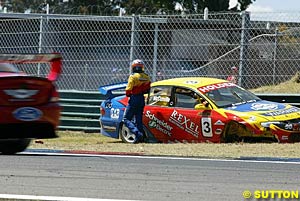 Cameron McConville stands by his wrecked Commodore in race two
