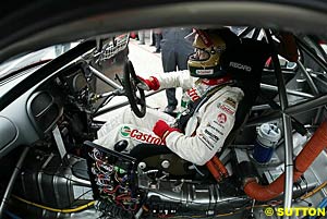 Larry Perkins sits in his car as he competes in his last regular V8 round