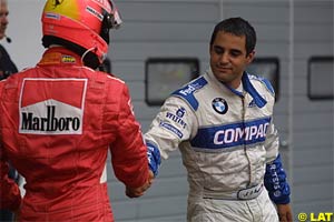 Montoya is congratulated by Schumacher
