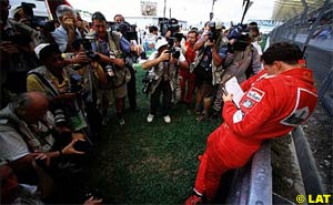 Michael Schumacher reads the report on Ferrari's disqualification Malaysian Grand Prix