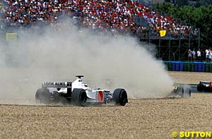 Olivier Panis and Takuma Sato go off the track