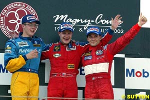 Left to right, second place finisher Sebastien Bourdais, winner Tomas Enge and third place finisher Giorgio Pantano celebrate on the podium