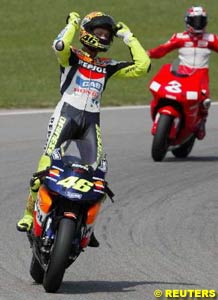 Valentino Rossi celebrates after his eighth win in nine races