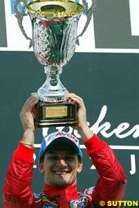 Winner Giorgio Pantano celebrates with the winner's trophy