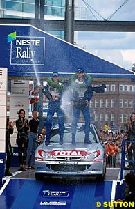 Marcus Gronholm and Timo Rautianen celebrate their third Rally Finland win in three years