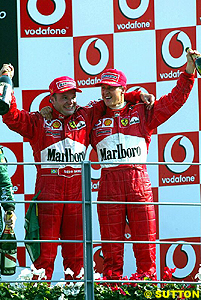Rubens Barrichello and Michael Schumacher celebrate their 1-2