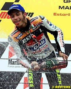 Valentino Rossi sprays champagne on the podium at Estoril