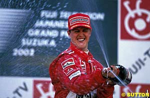 Michael Schumacher celebrates his 11th win of 2002