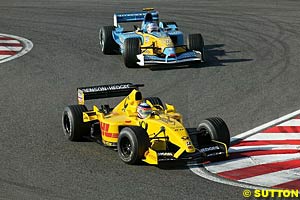 Sato battles it out with Trulli
