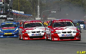 HRT's Jason Bright leads team mate Mark Skaife into the first corner at the start of Race 1