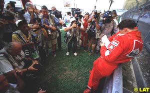 Michael Schumacher reads his disqualification notice in 1999