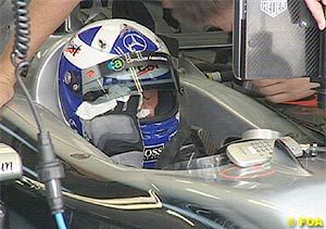 David Coulthard wipes his sweat during qualifying
