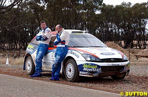 Colin McRae and Derek Ringer stand beside their retired Focus