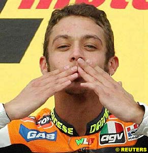 Winner Valentino Rossi blows a kiss on the podium