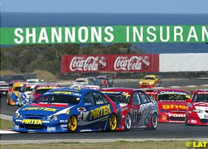 Marcos Ambrose under attack from Mark Skaife at the start of race one