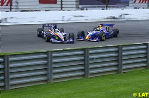 Jaques Lazier, left, and Tomas Scheckter, right, make contact