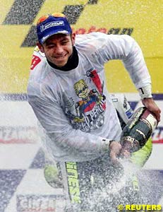 Valentino Rossi celebrates winning the MotoGP title on the podium in Rio